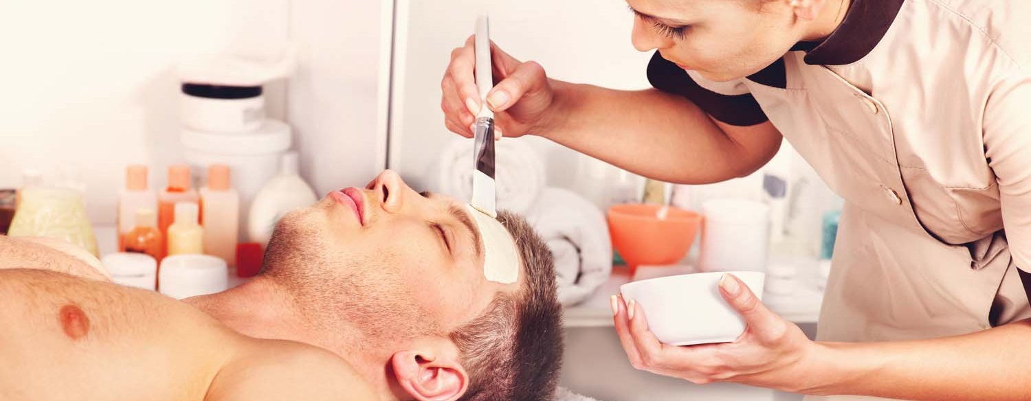 woman applying face mask to a man