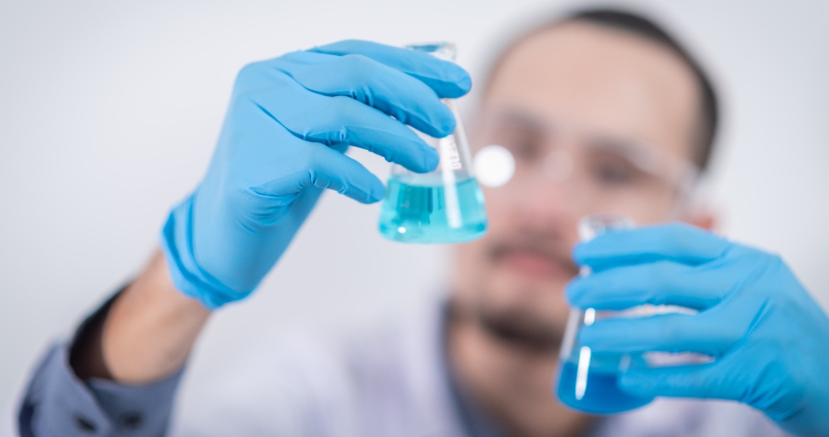 person holding glass flasks